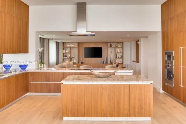 a bathroom with a granite countertop sink and a large mirror