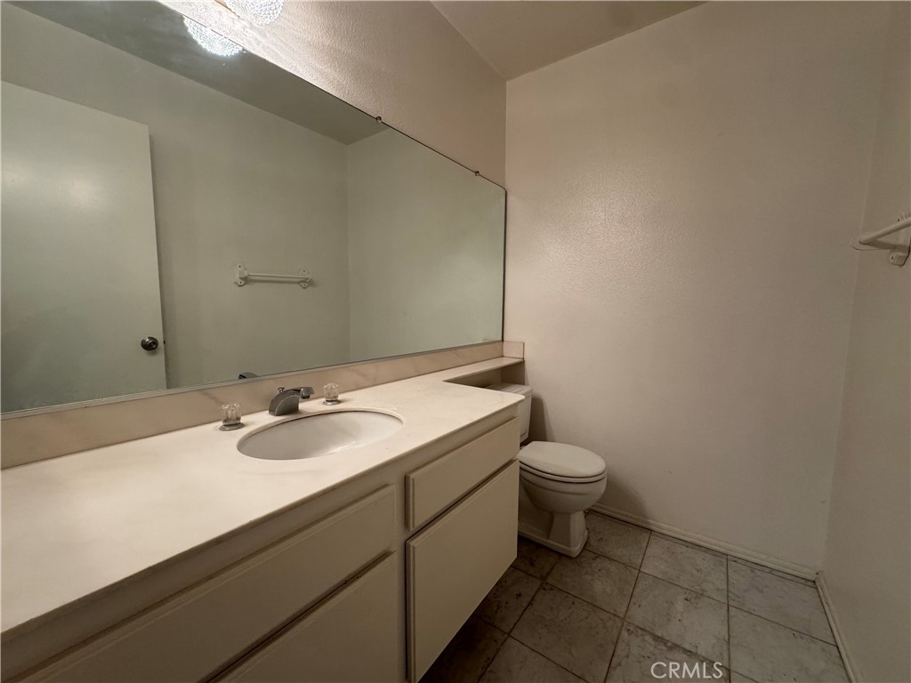 1819 Molokai Street West Covina, CA 91792 - Photo 12 of 25 a bathroom with a granite countertop sink and a mirror