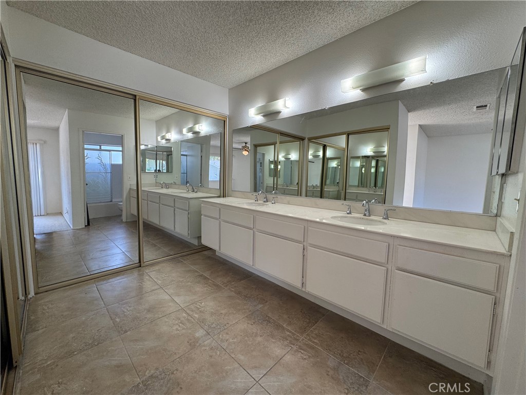 1819 Molokai Street West Covina, CA 91792 - Photo 8 of 25 a large bathroom with a large mirror vanity and shower