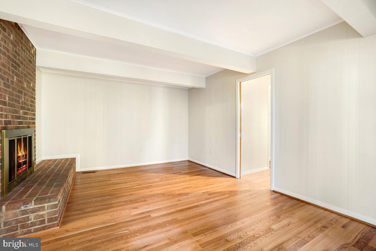 2606 Deerdell Lane Reston, VA 20191 - Photo 19 of 49 a view of an empty room with wooden floor and a fireplace