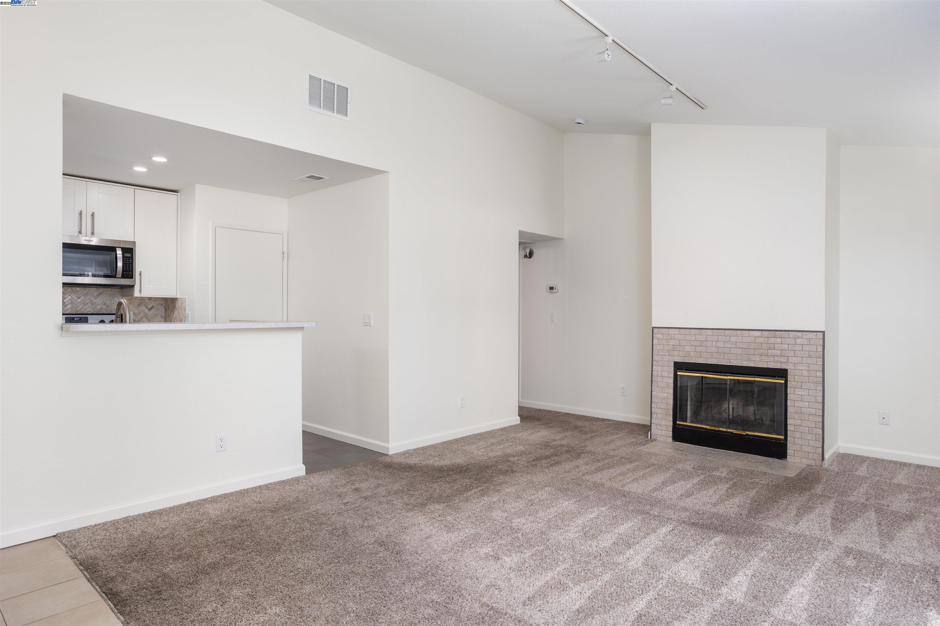 140 Reflections Drive, Unit 24 San Ramon, CA 94583 - Photo 12 of 32 a view of an empty room with a fireplace