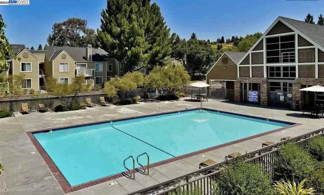 a view of a house with a backyard and sitting area