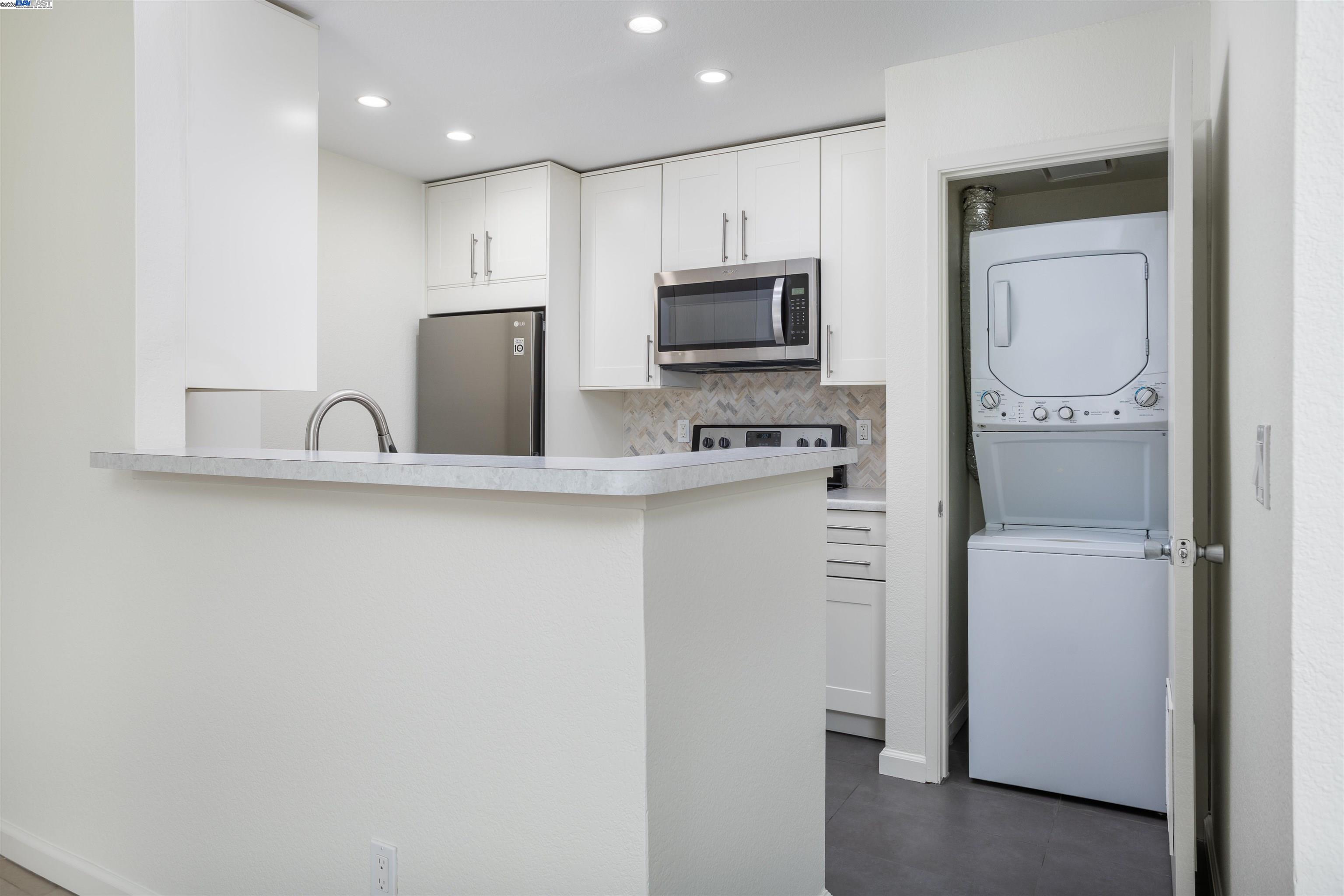 140 Reflections Drive, Unit 24 San Ramon, CA 94583 - Photo 8 of 32 a kitchen with a refrigerator a microwave a sink and cabinets
