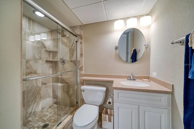 a bedroom with two beds and a chandelier