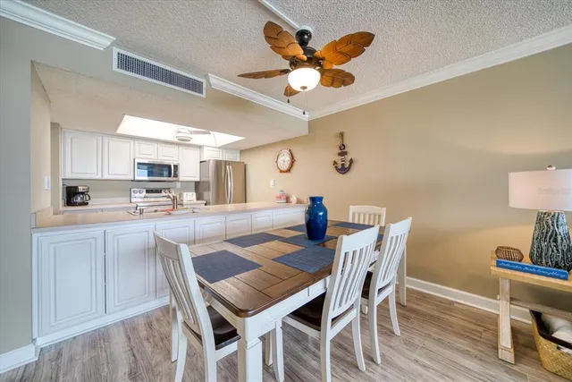 a kitchen with stainless steel appliances granite countertop a sink dishwasher stove and microwave with wooden floor
