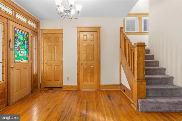 a view of a room with wooden floor and entryway