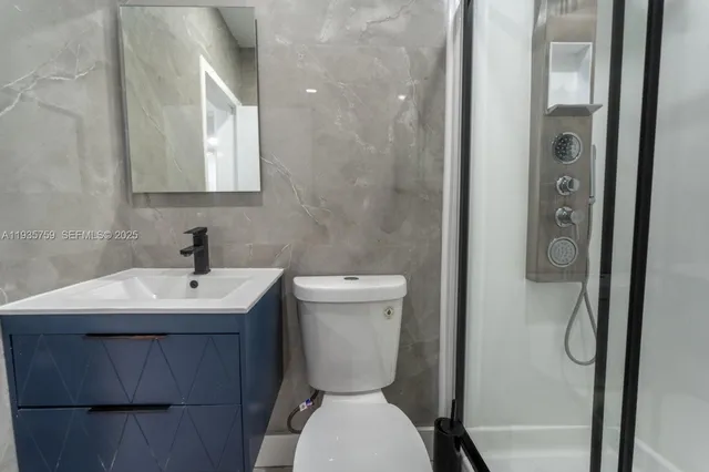 a bathroom with a toilet sink and mirror