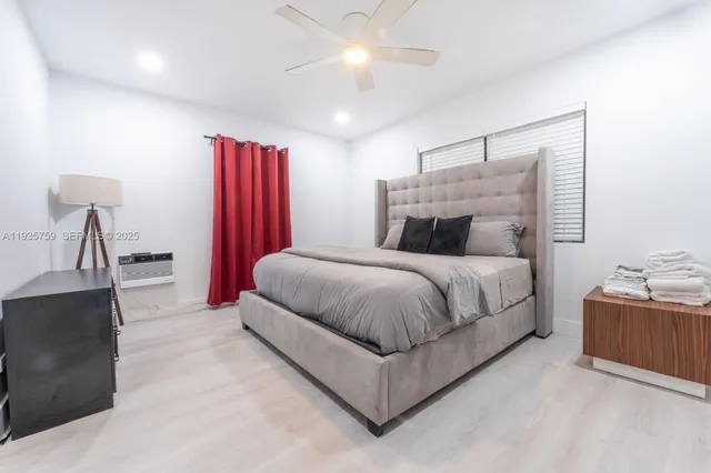 a spacious bedroom with a bed and a chandelier
