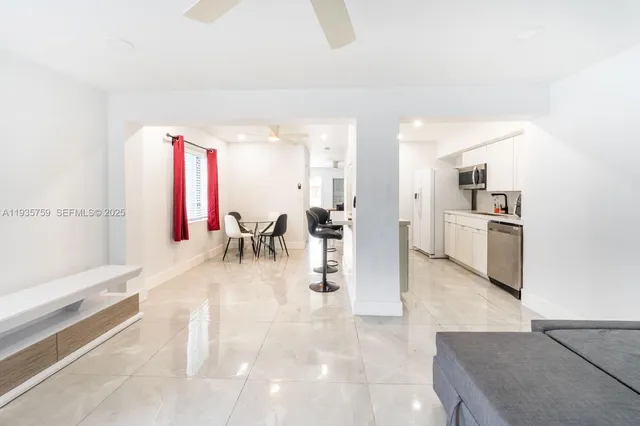 a view of a kitchen with a dining table chairs and entryway