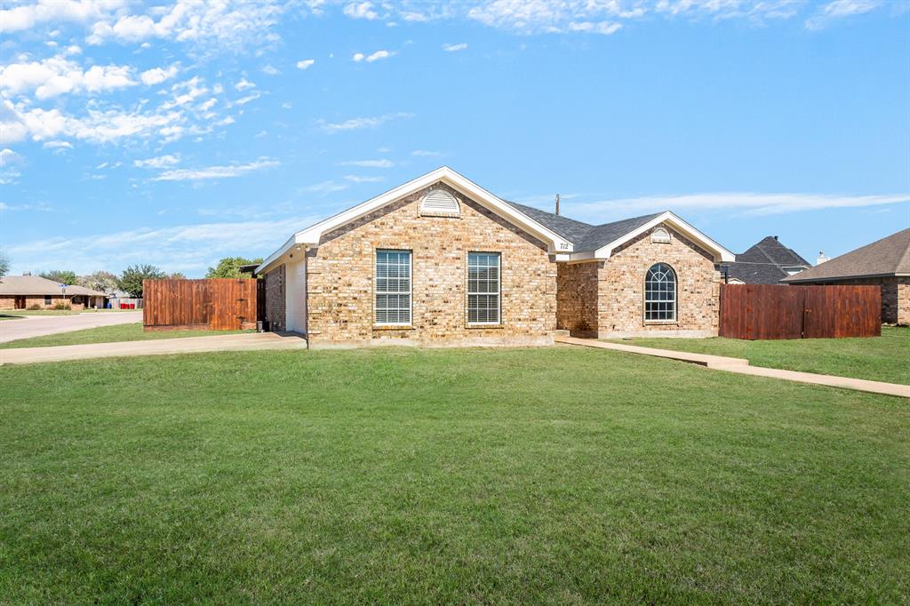 712 Billups Street Van Alstyne, TX 75495 - Photo 2 of 38 a view of a big house with a big yard and large trees