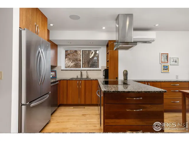 a kitchen with granite countertop a stove and a sink