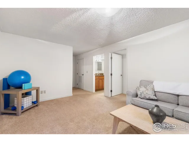 a bathroom with a granite countertop sink a toilet a mirror and shower