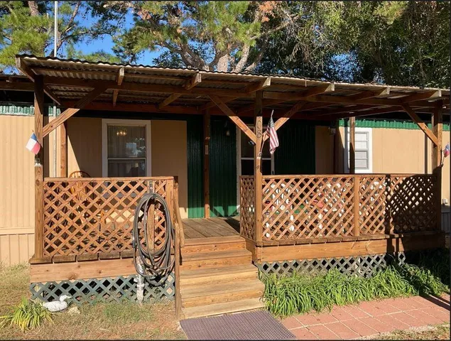 a view of a wooden door with a bench in front of it