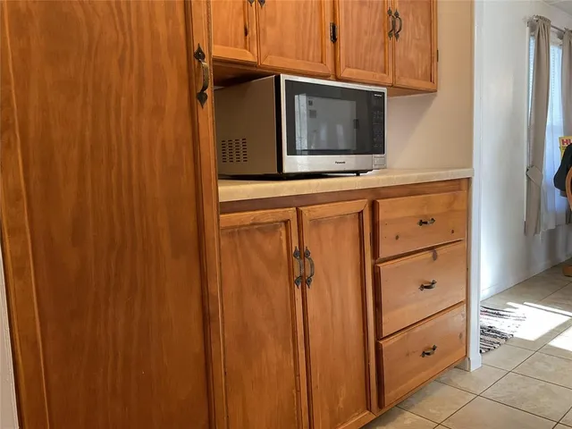 a kitchen with a sink cabinets and window