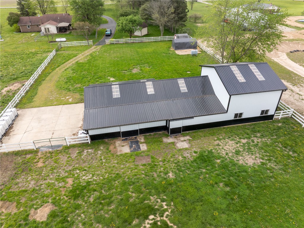 7988 McCool Road Greenville, OH 45331 - Photo 46 of 50 An aerial perspective showcases a vibrant green property with an extensive barn structure.
