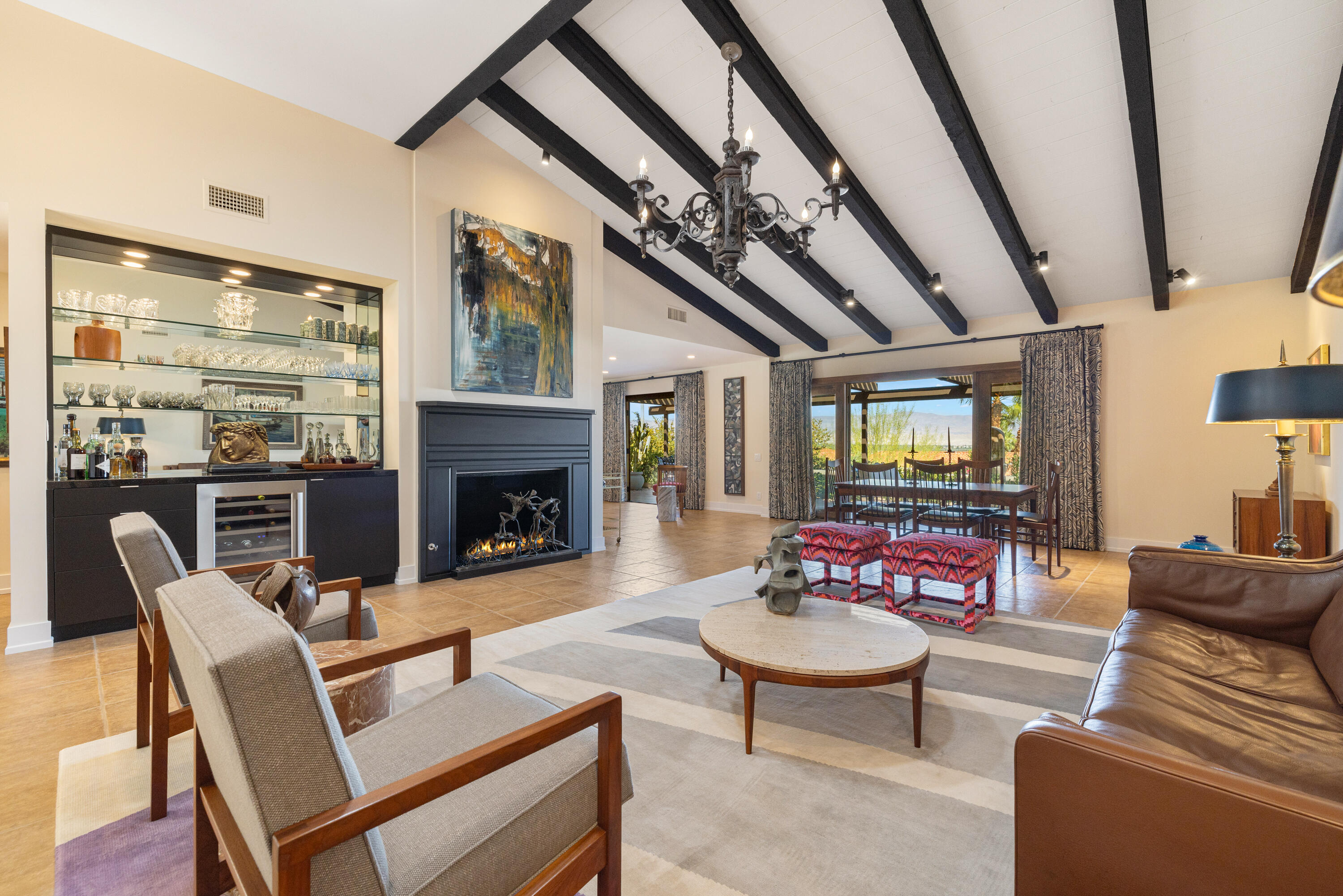a living room with furniture a fireplace a rug and a window