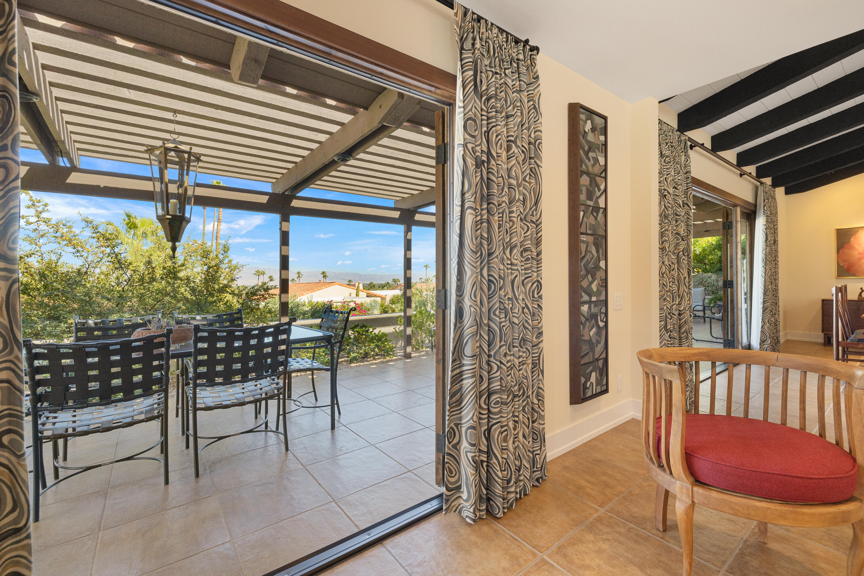 40170 Paseo Lindo Rancho Mirage, CA 92270 - Photo 18 of 51 a view of a porch with furniture and floor to ceiling window