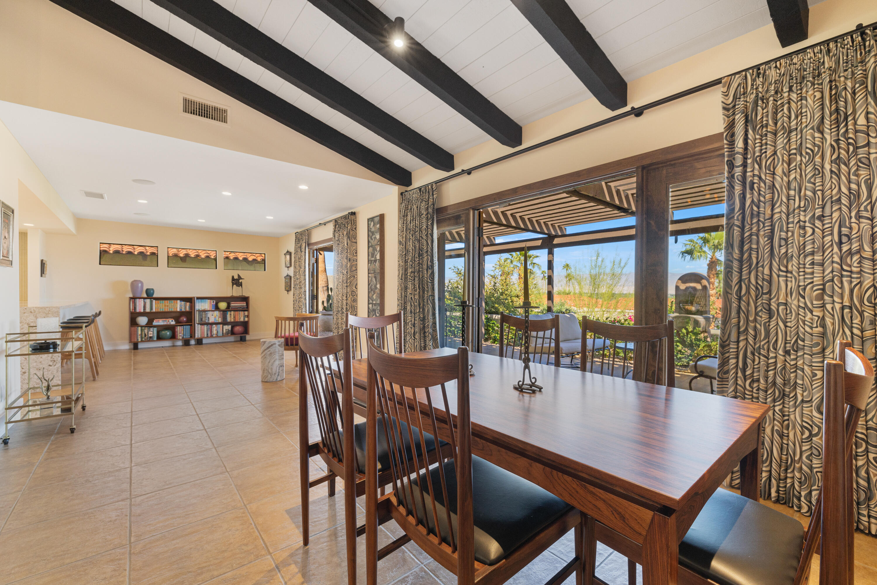 40170 Paseo Lindo Rancho Mirage, CA 92270 - Photo 21 of 51 a dining room with furniture floor to ceiling windows and plants