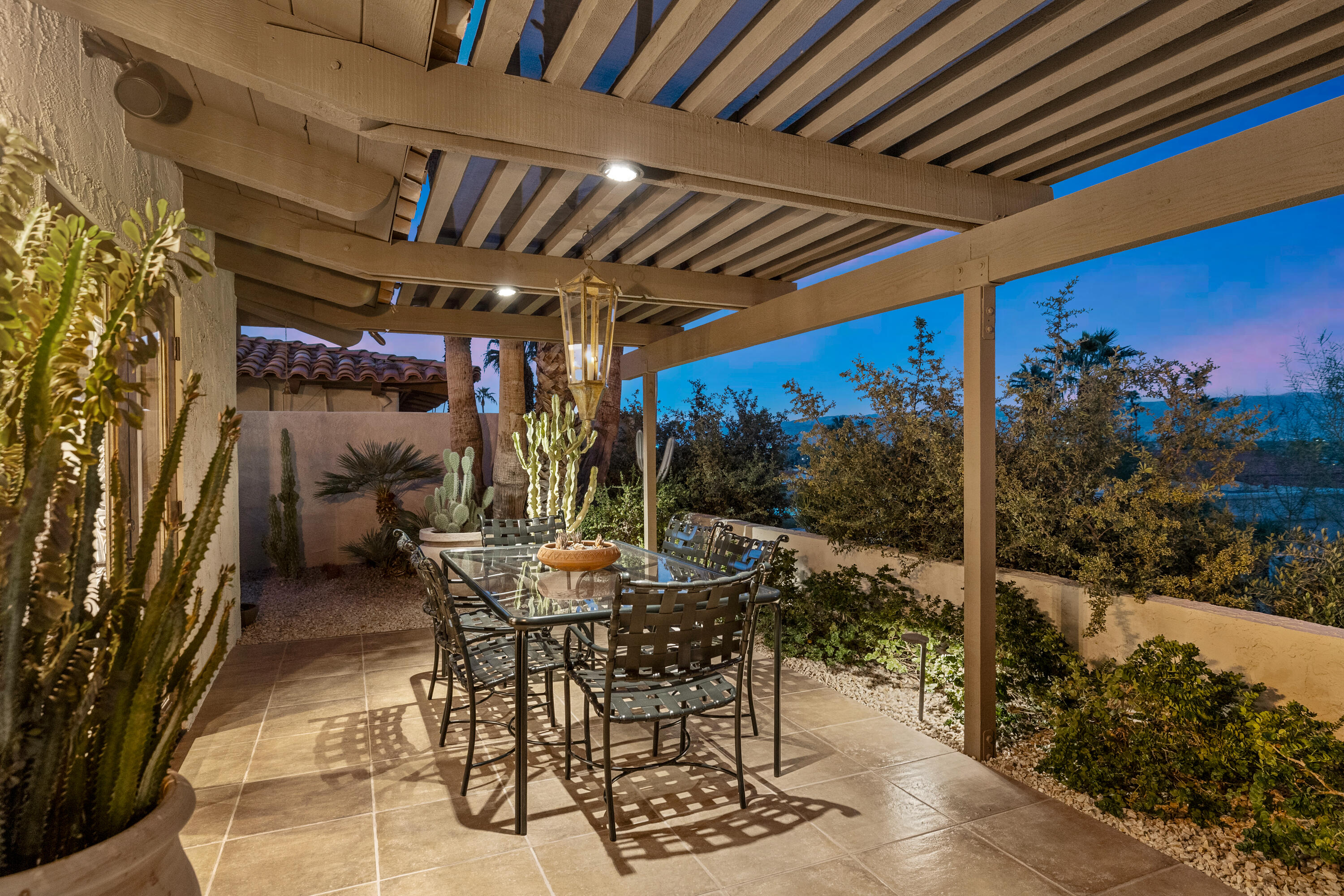 40170 Paseo Lindo Rancho Mirage, CA 92270 - Photo 27 of 51 a view of an outdoor space with table and chairs with the potted plants