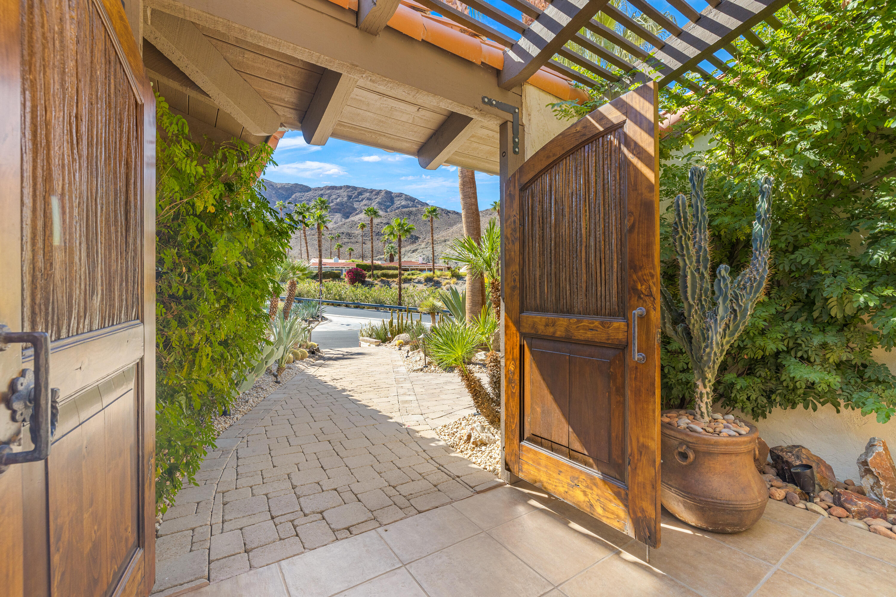 40170 Paseo Lindo Rancho Mirage, CA 92270 - Photo 8 of 51 a view of a patio with table and chairs under an umbrella