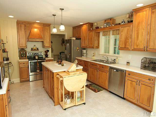 511 Mason Road Durham, NC 27712 - Photo 6 of 25 Country Kitchen with tons of cabinet storage. New Dishwasher and Stove. Easy access to the laundry & mud room. Kitchen
