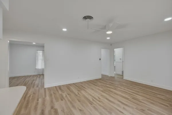 a view of a room with wooden floor and stairs