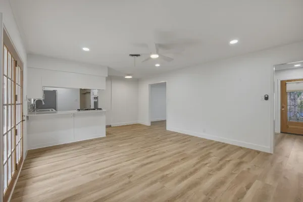 a view of a kitchen with a sink and a refrigerator