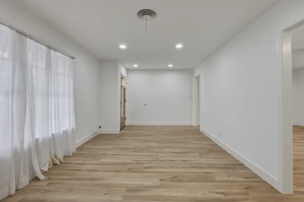 a view of a room with wooden floor and stairs