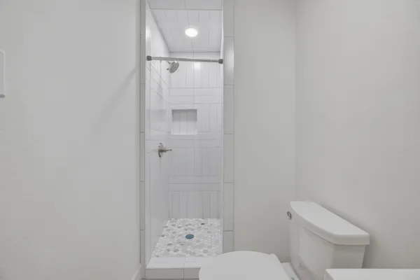a white toilet sitting next to a bathroom sink