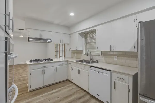 a kitchen with a sink stove and refrigerator