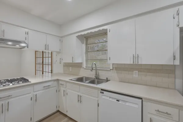 a kitchen with a sink cabinets and window