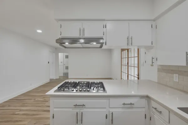 a kitchen with a sink stove and refrigerator
