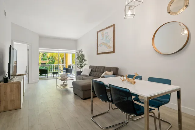 a view of a livingroom with furniture window and wooden floor