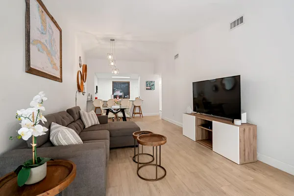 a living room with furniture and a flat screen tv