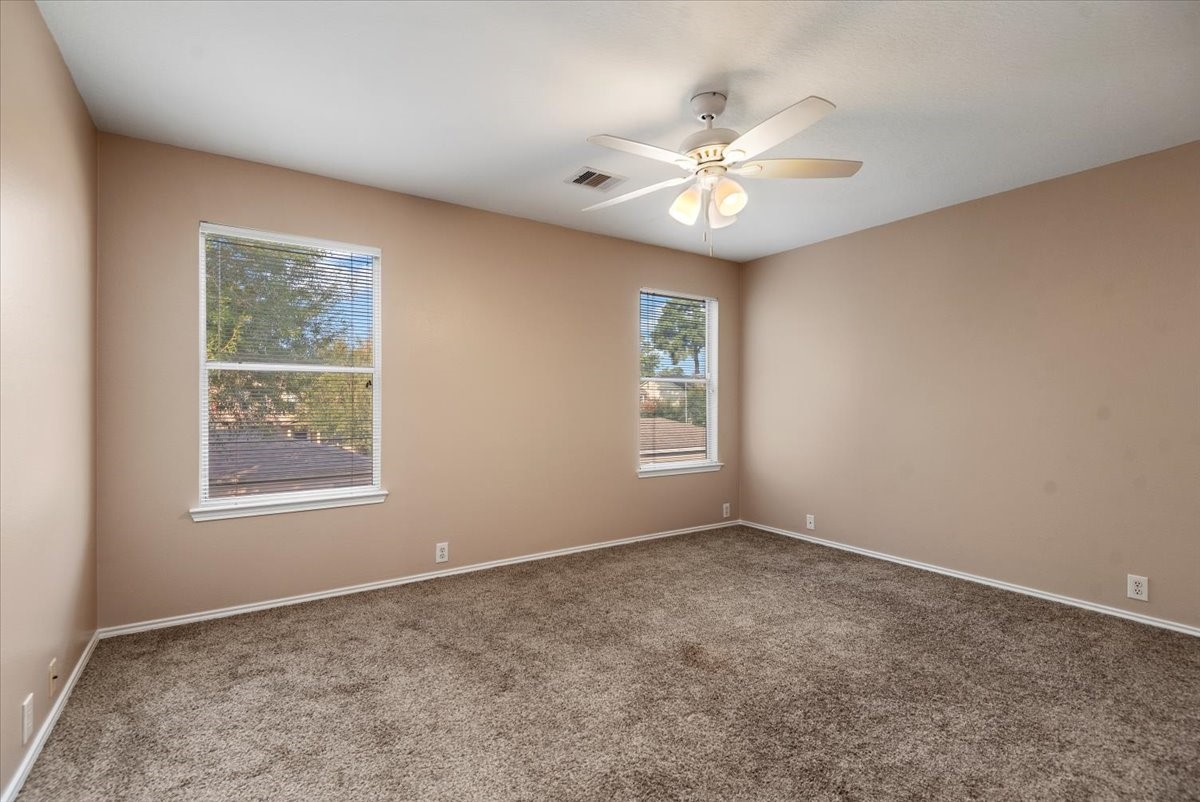 23611 Youpon Lake Lane Spring, TX 77373 - Photo 15 of 25 an empty room with windows and chandelier fan