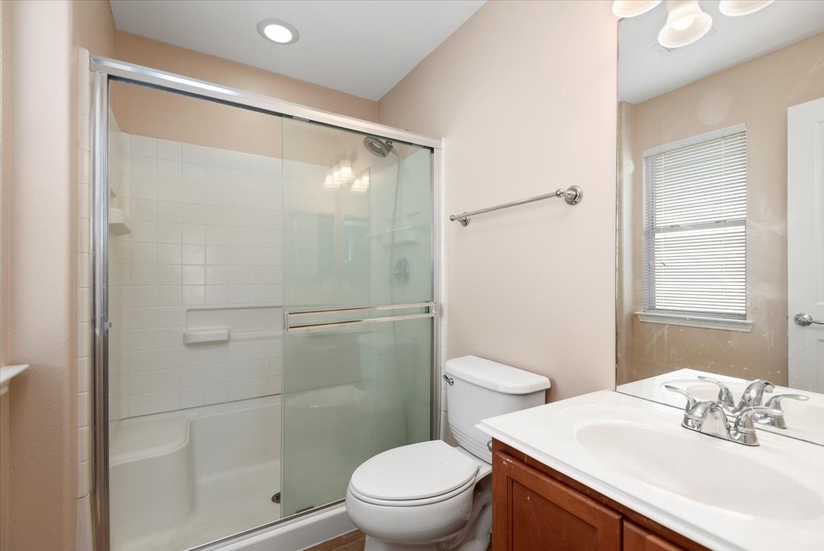 23611 Youpon Lake Lane Spring, TX 77373 - Photo 17 of 25 a bathroom with a granite countertop sink toilet and shower