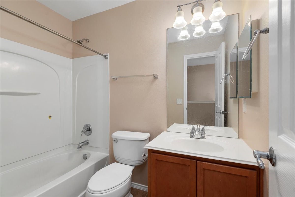 23611 Youpon Lake Lane Spring, TX 77373 - Photo 19 of 25 a bathroom with a sink toilet a mirror and shower