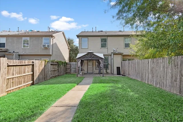 a view of a house with backyard and porch