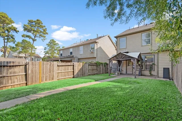 a view of a house with a yard and sitting area