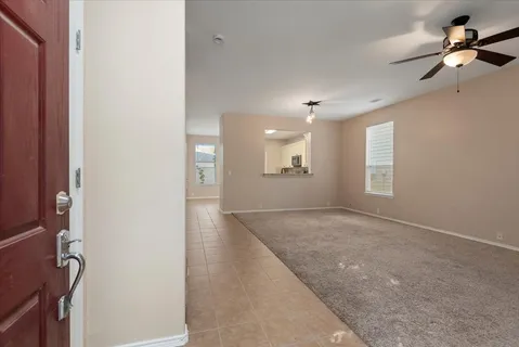 an empty room with windows and cabinet