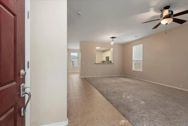 an empty room with windows and cabinet