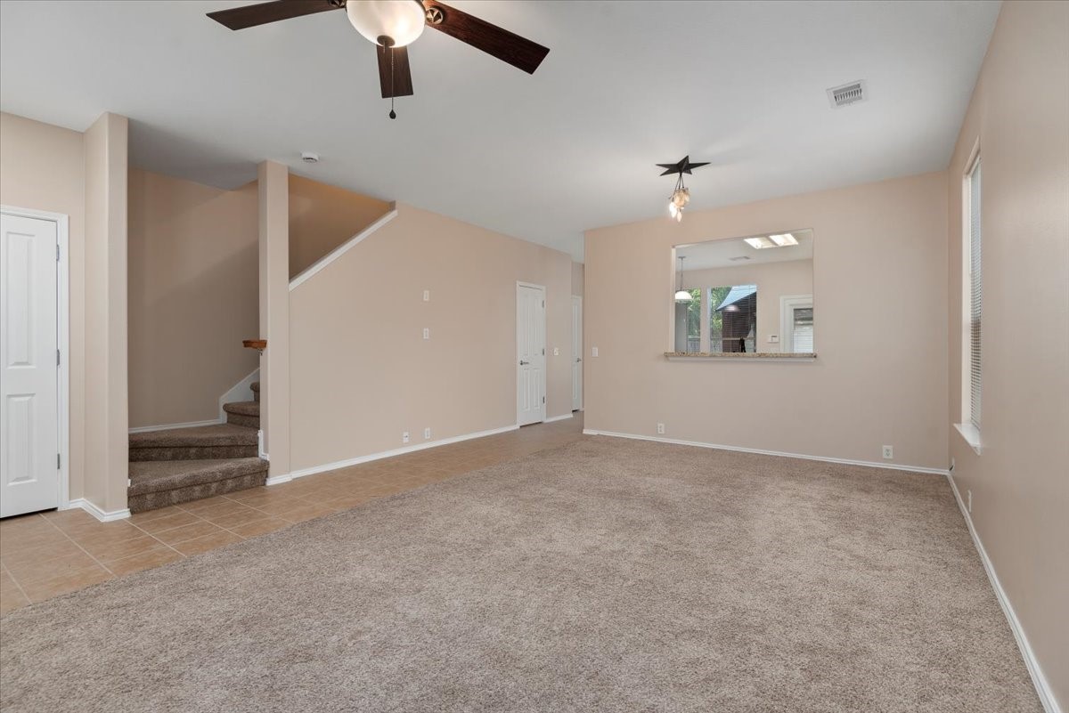 23611 Youpon Lake Lane Spring, TX 77373 - Photo 4 of 25 an empty room with windows and ceiling fan