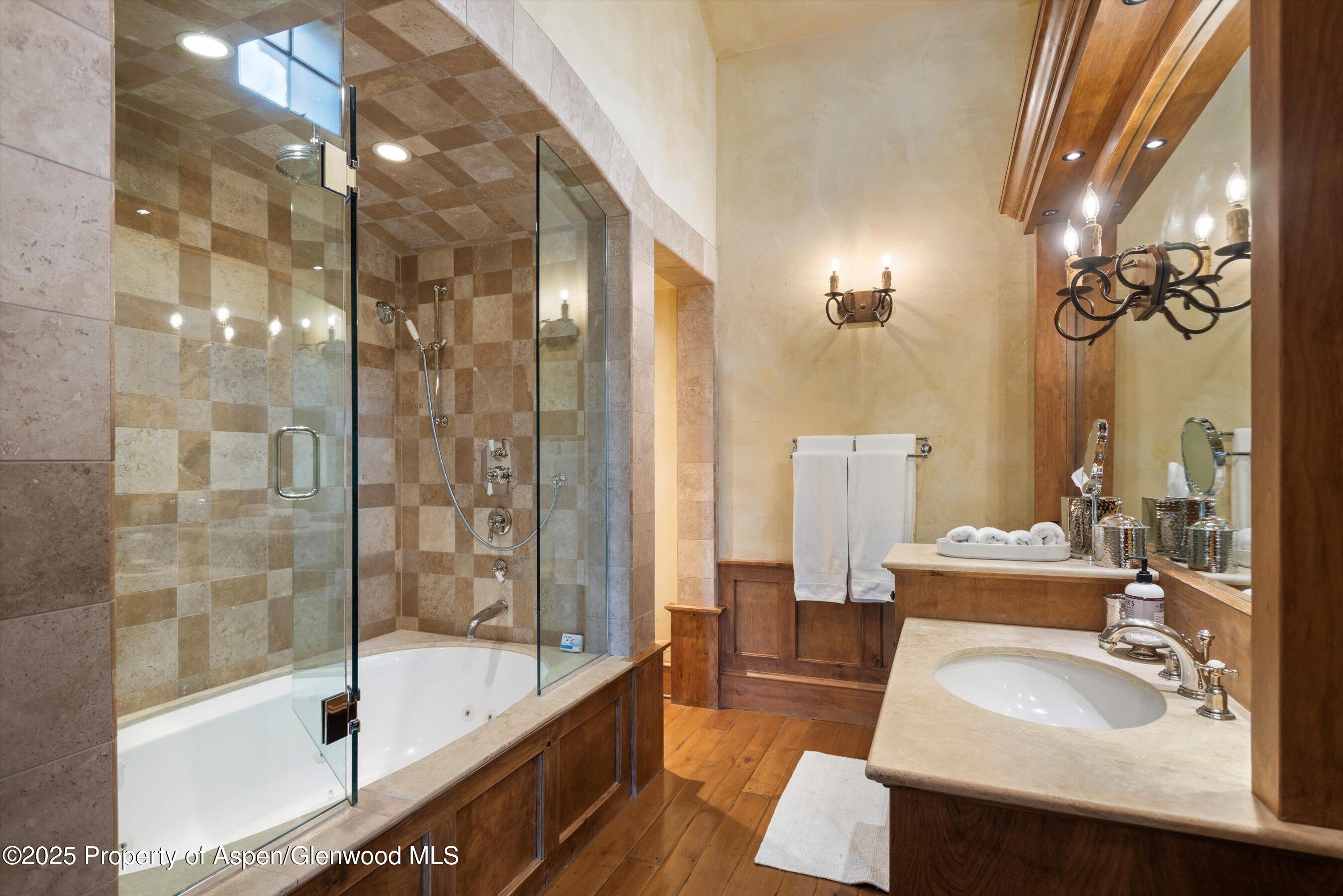 Aspen Central Core Aspen, CO 81611 - Photo 11 of 26 a bathroom with a tub sink and mirror