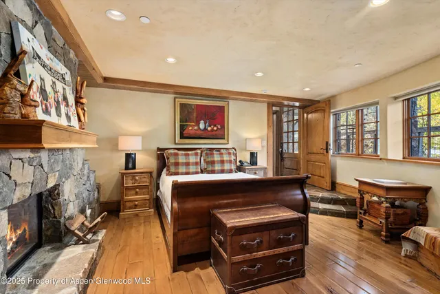 a bedroom with furniture and a fireplace