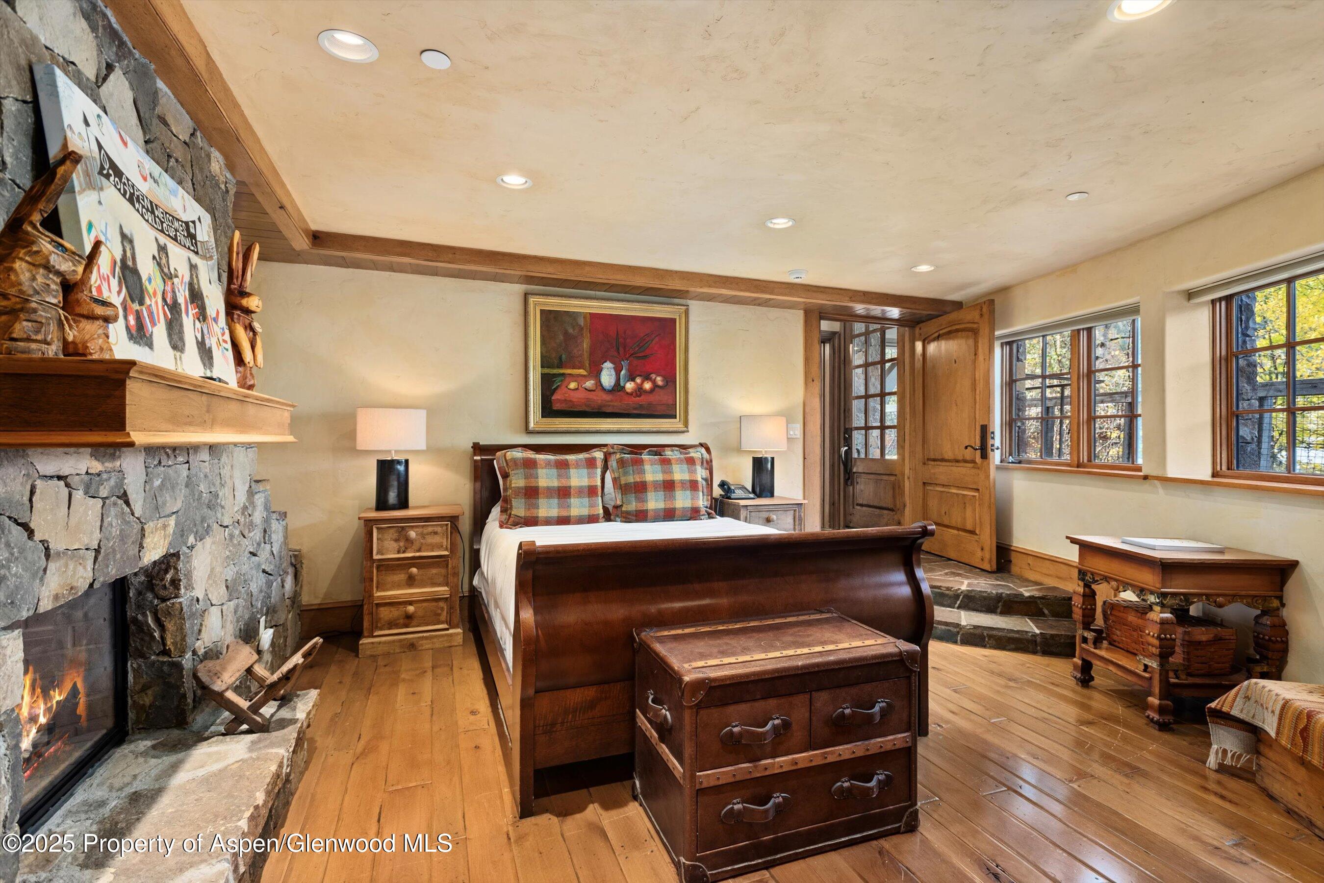 Aspen Central Core Aspen, CO 81611 - Photo 14 of 26 a bedroom with furniture and a fireplace