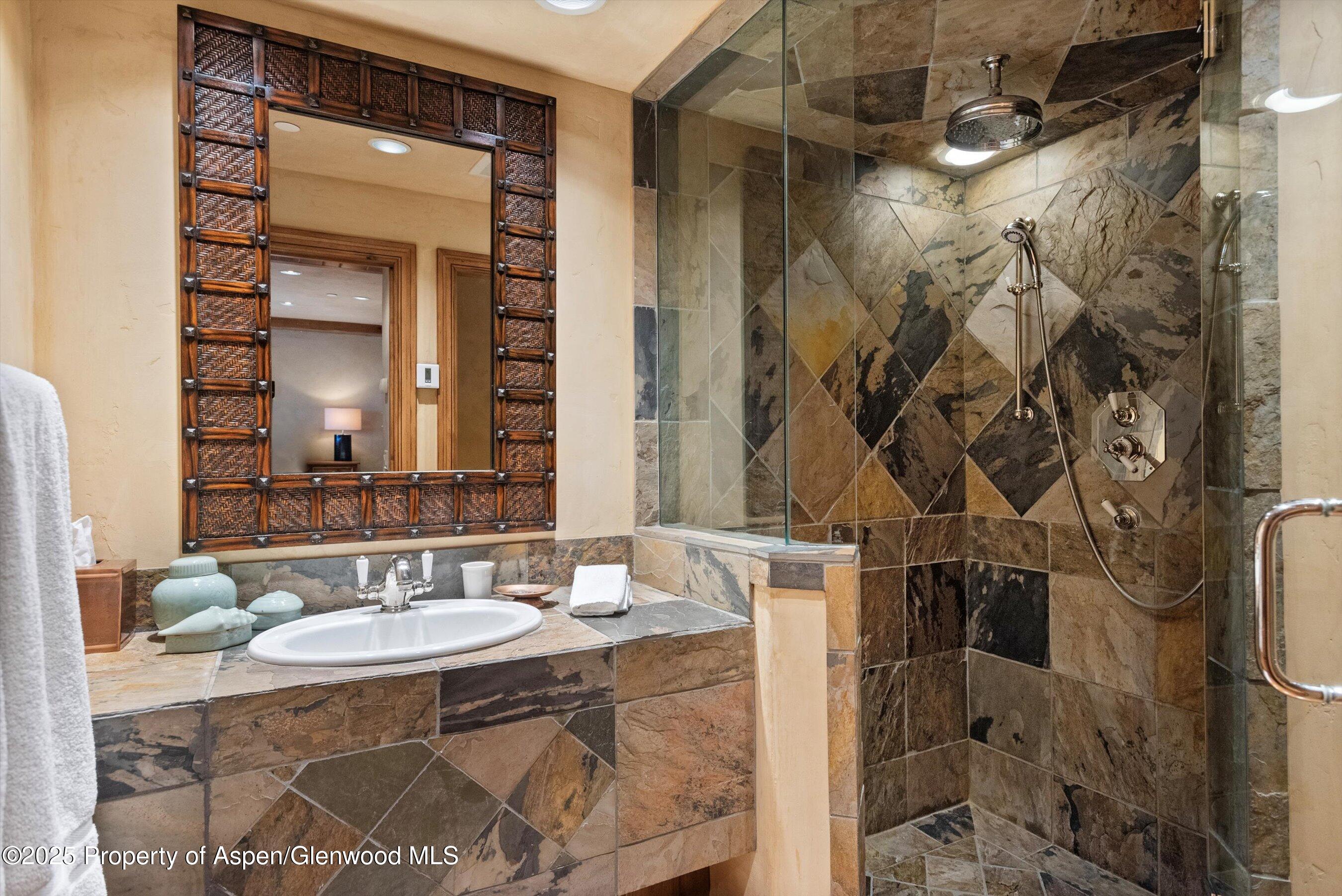 Aspen Central Core Aspen, CO 81611 - Photo 15 of 26 a bathroom with a sink and a mirror