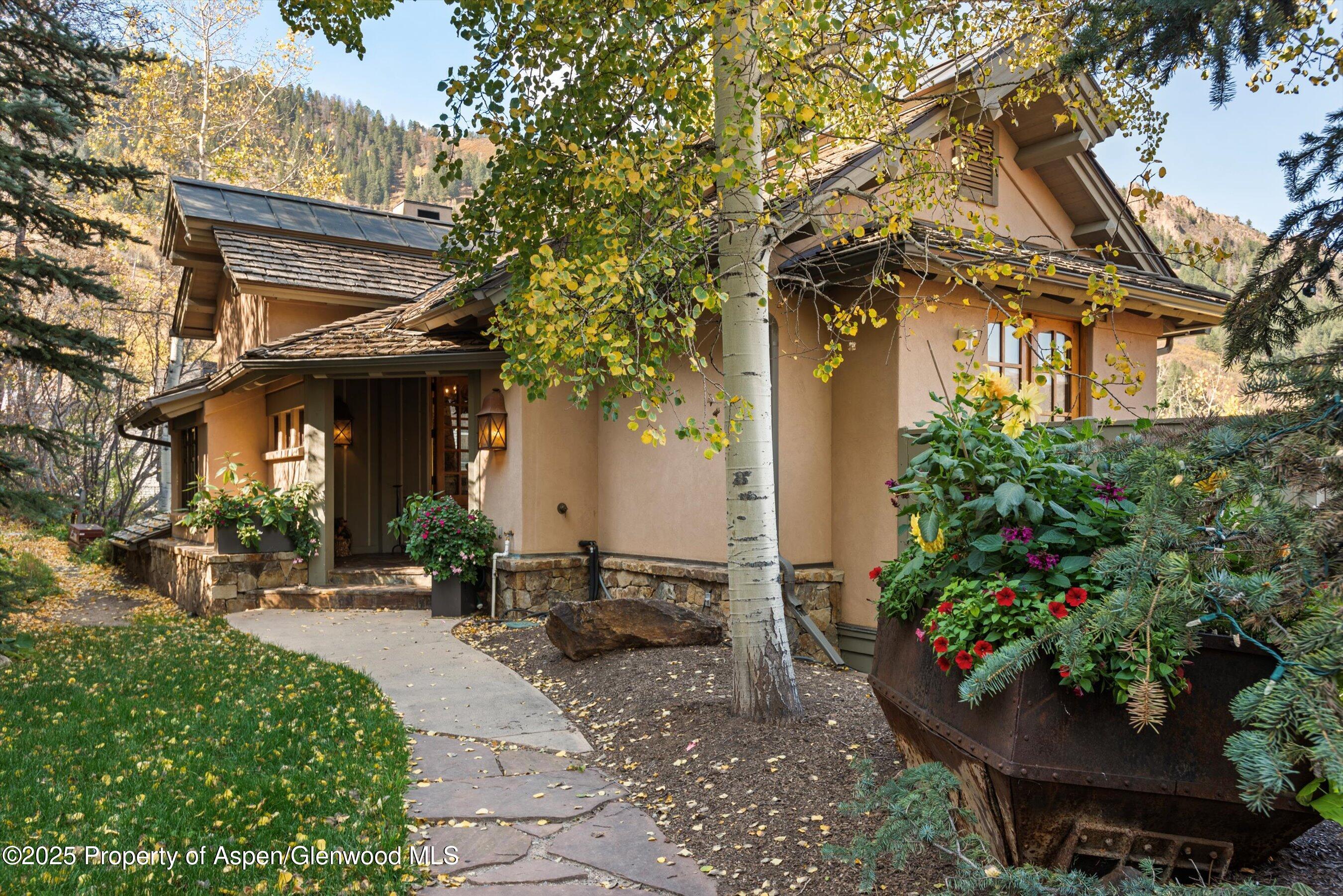 Aspen Central Core Aspen, CO 81611 - Photo 20 of 26 a view of a house with a flower garden