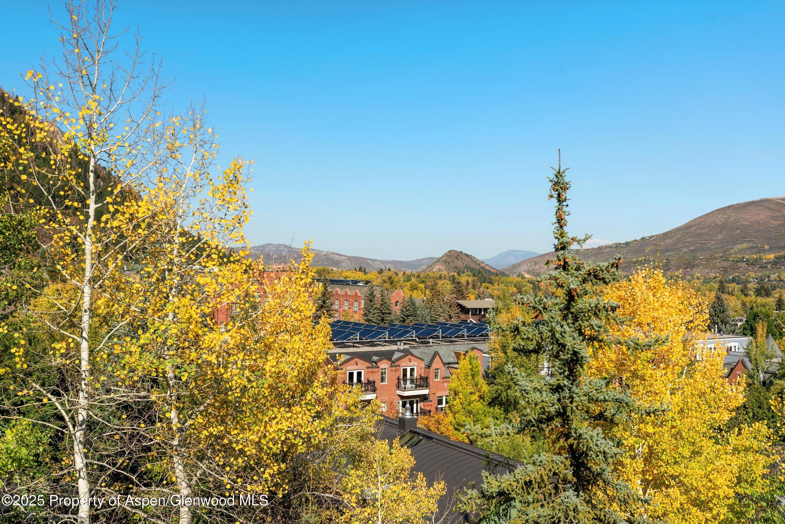 Aspen Central Core Aspen, CO 81611 - Photo 22 of 26 a view of a large building with a mountain in the background