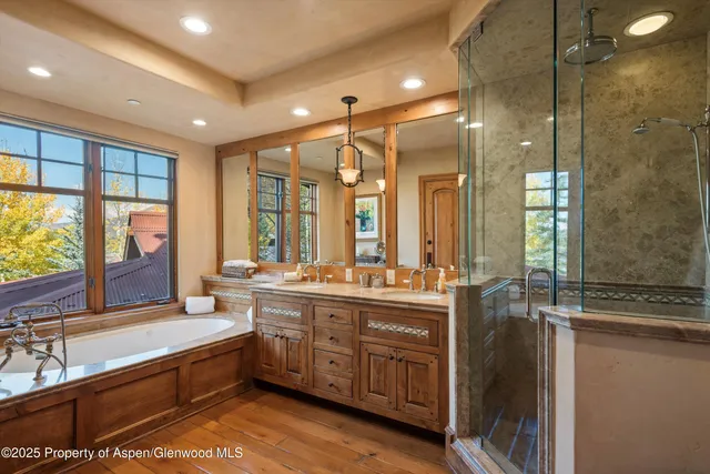a large bathroom with a large tub and sink