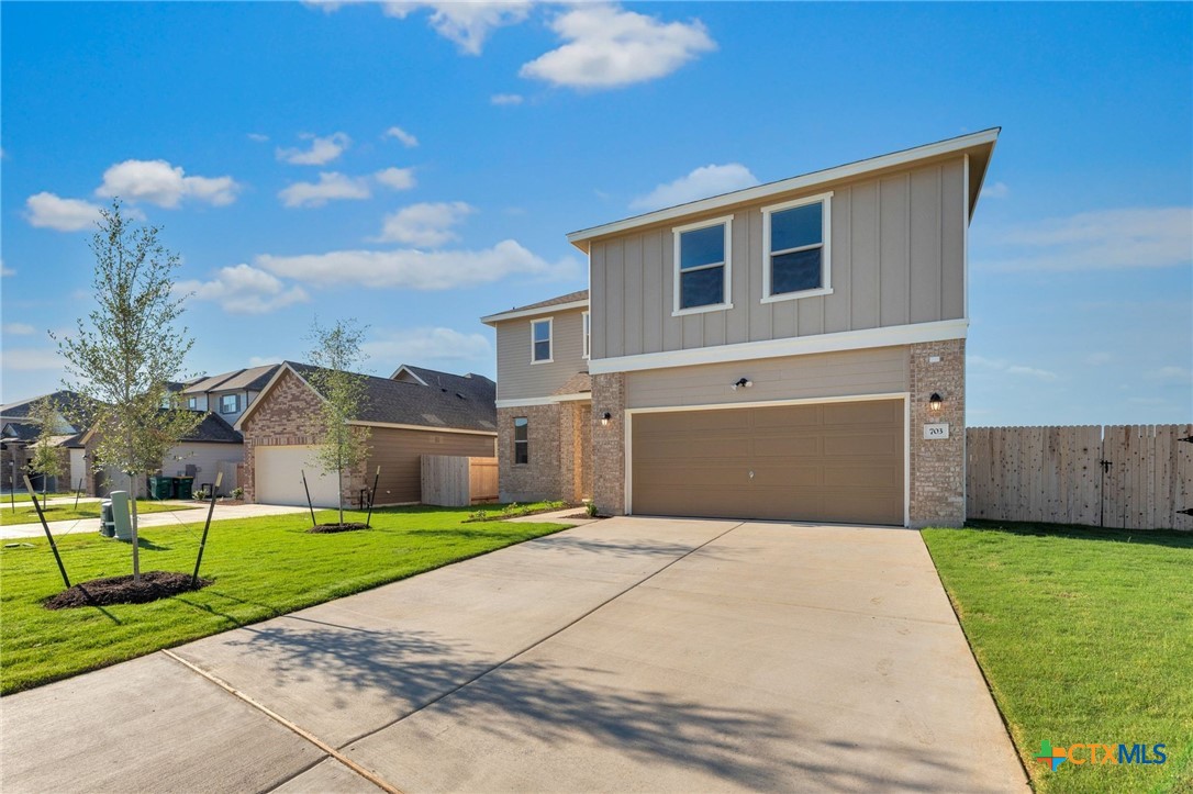 703 Ryan Street Belton, TX 76513 - Photo 3 of 44 a front view of a house with a yard and garage